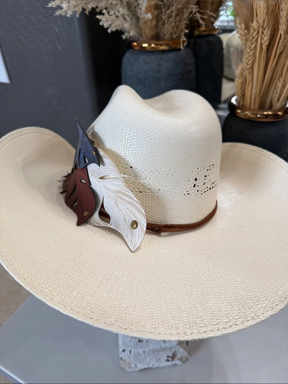 White Straw Cowboy Hat with Patriotic Red White and Blue Feathers.